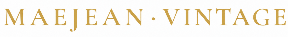 The text 'MAEJEAN • VINTAGE' is displayed in a gold serif typeface against a solid white background.